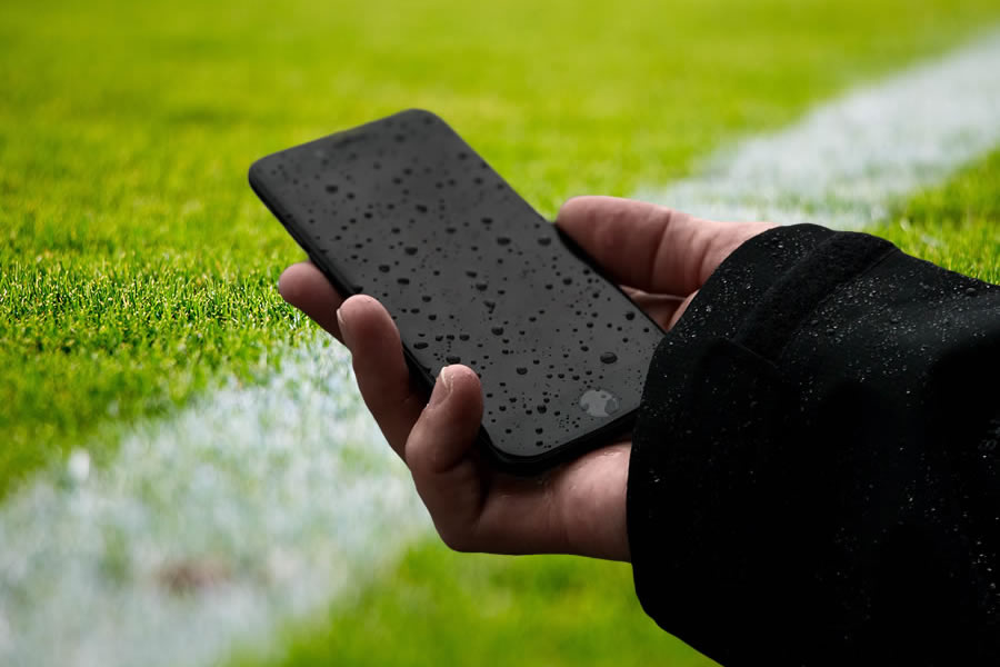 Wet Cellphone on a Soccer Field Image